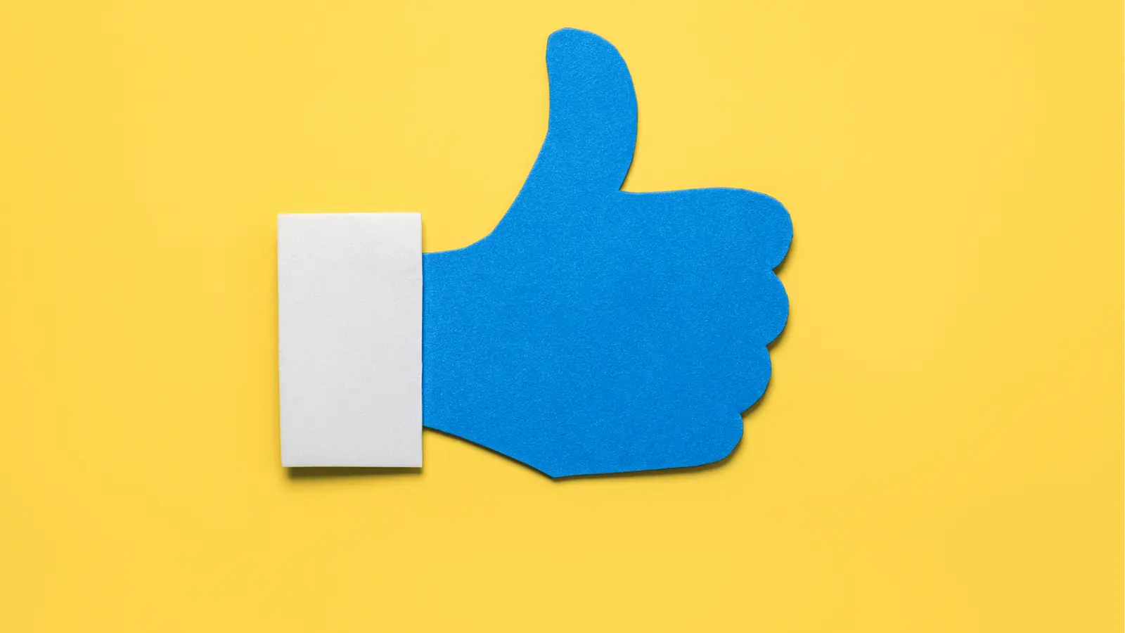 Blue thumbs-up cutout on yellow background with white cuff for inbox management