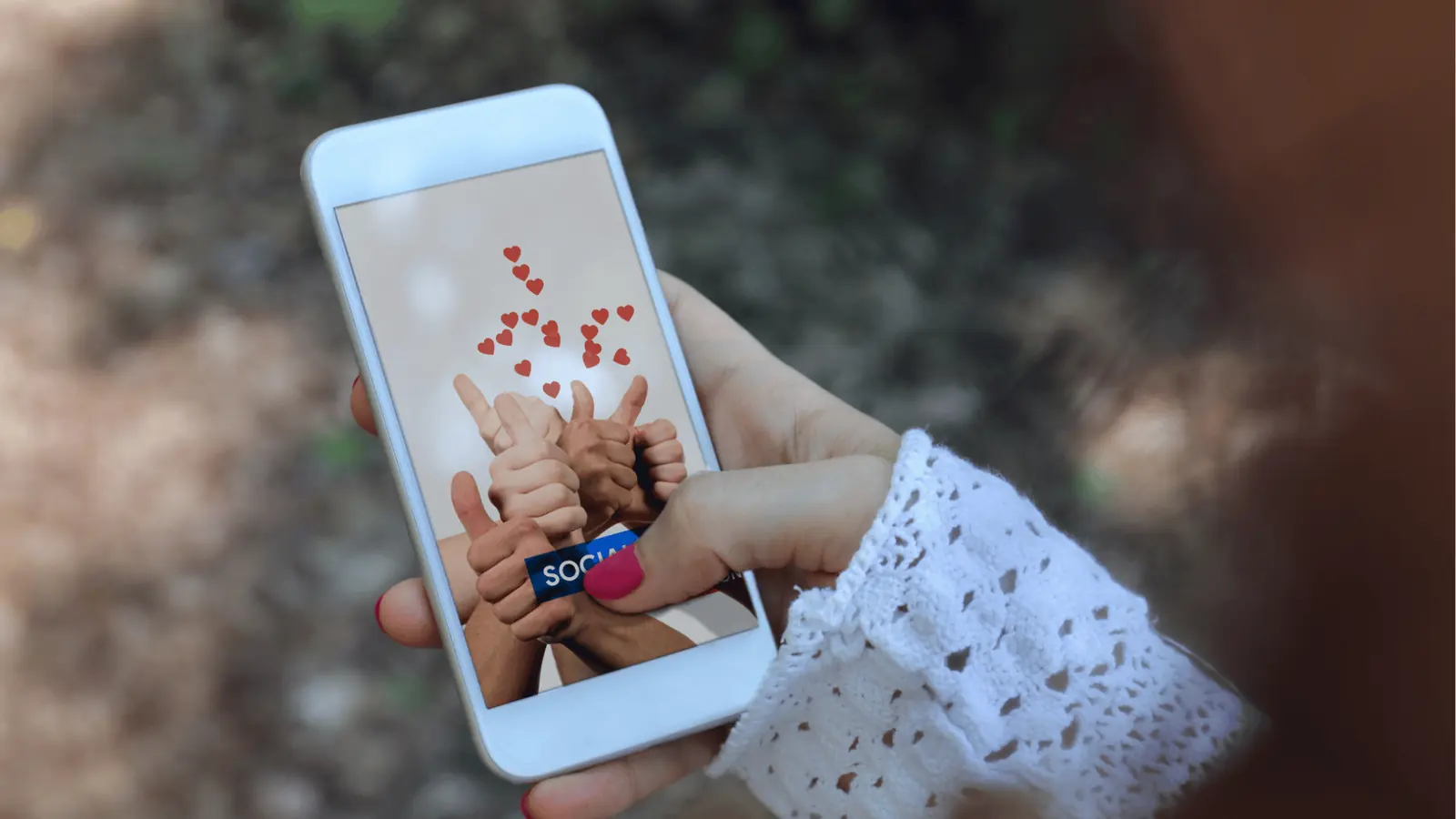 Hand holding smartphone showing thumbs-up graphics and floating red hearts for scheduling