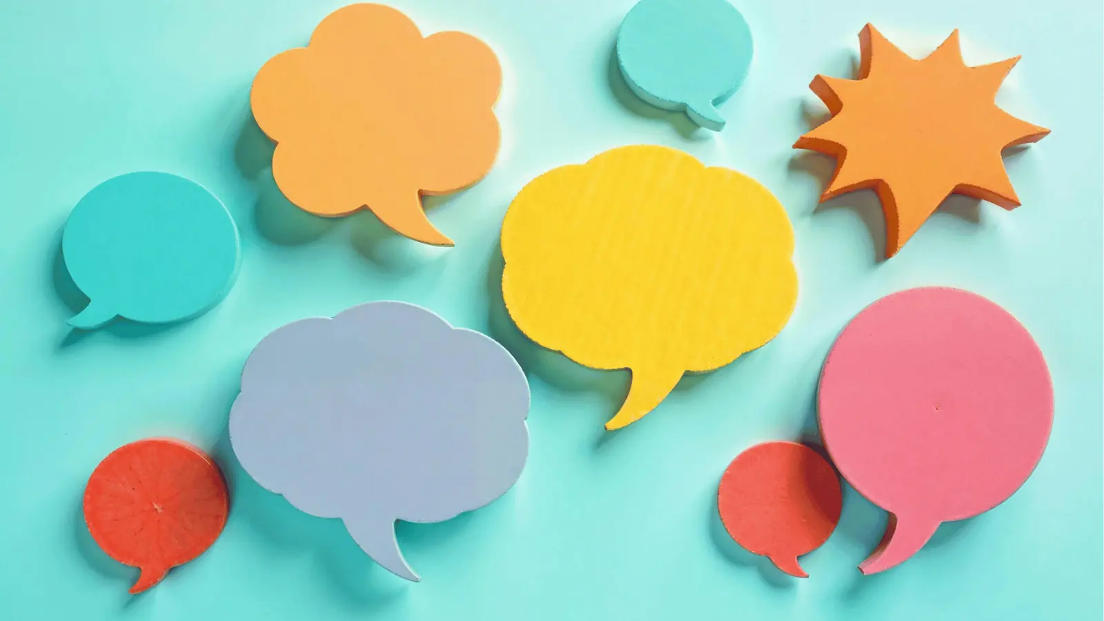 Colorful speech bubble cutouts arranged on a light teal background for automation