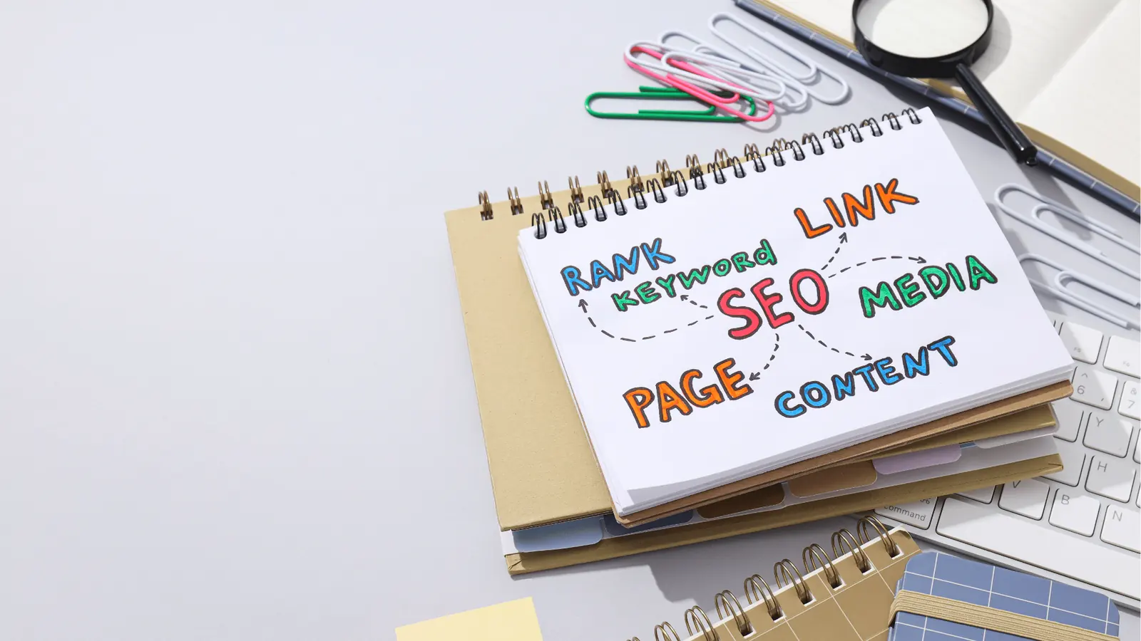 Spiral notebook with colorful hand-drawn SEO mindmap on desk for scheduling