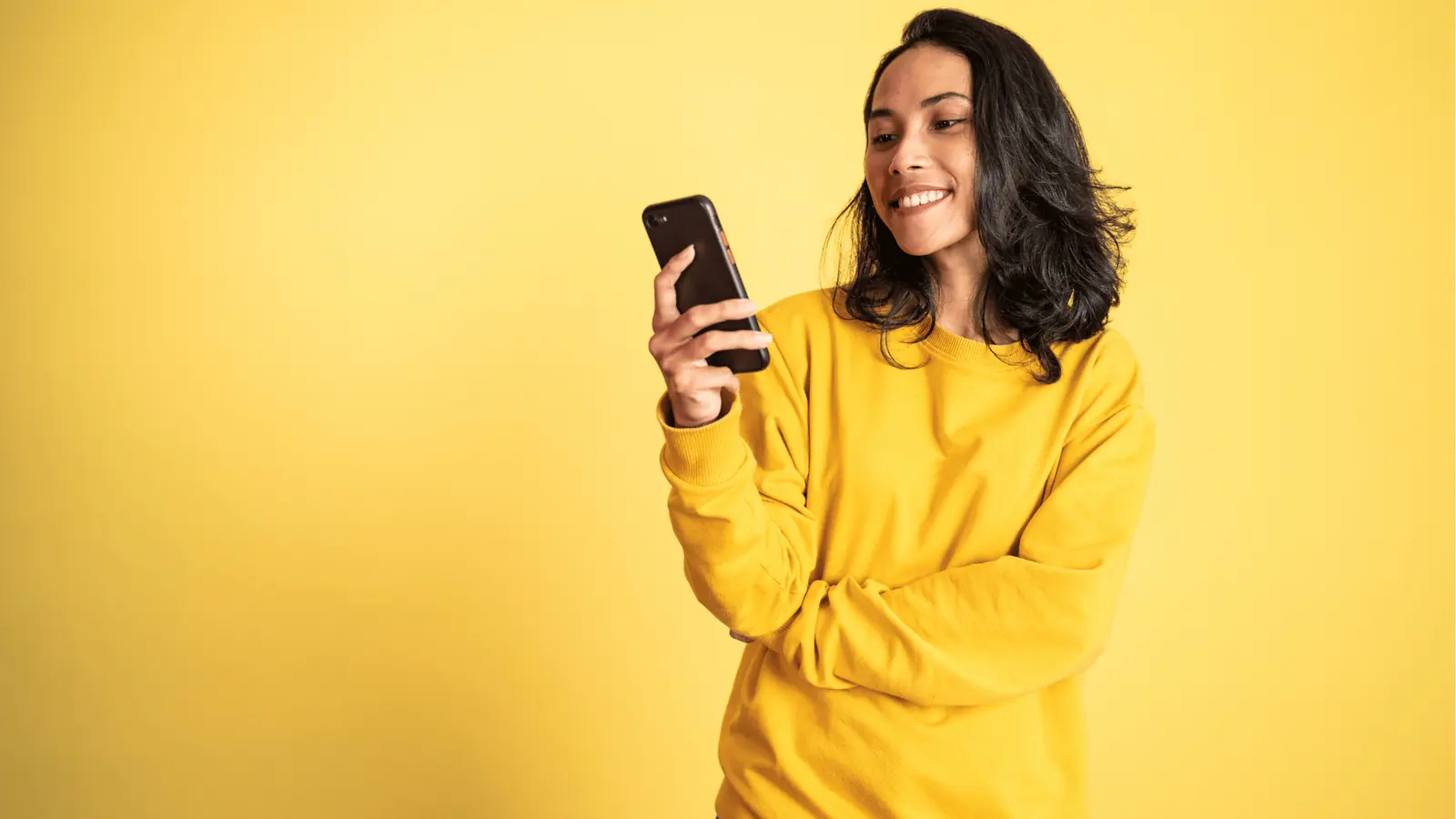 Smiling woman looking at her phone