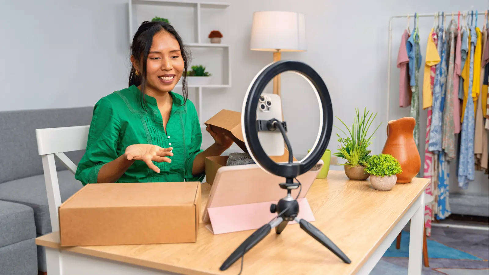 Woman unboxing a product on video with ring light and smartphone